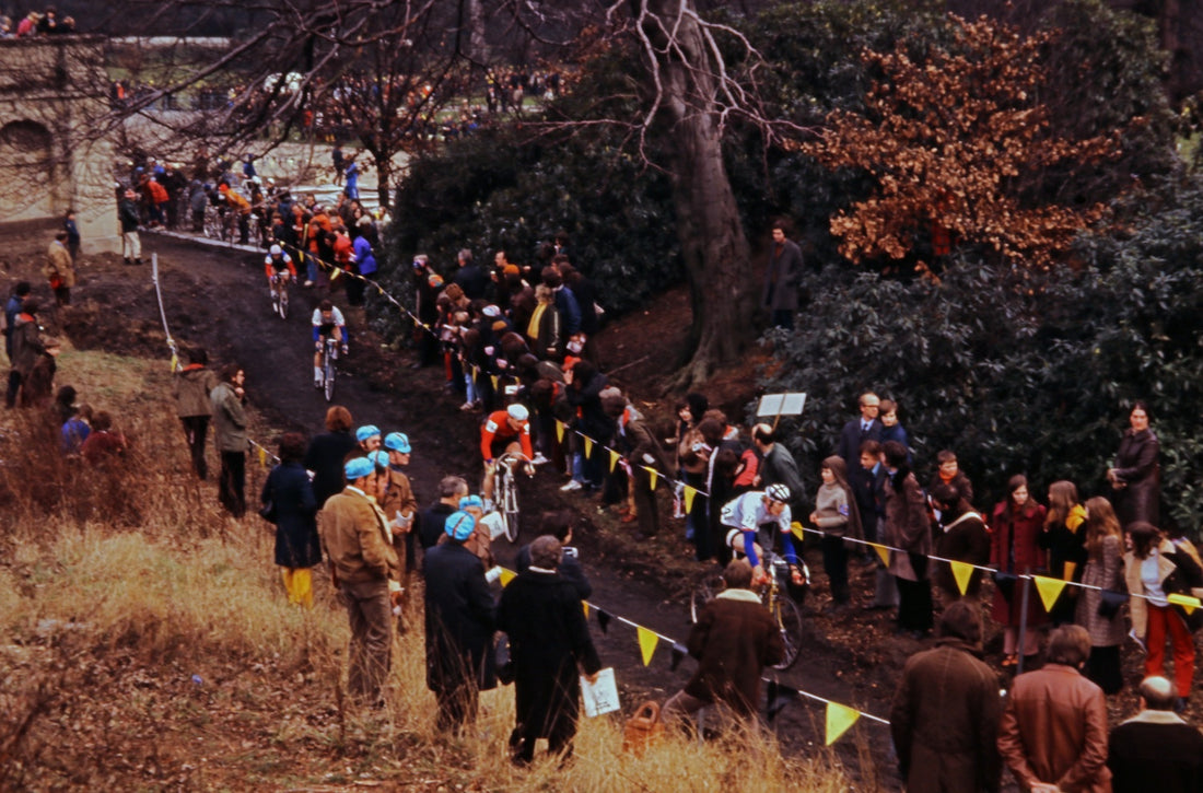 On the bike, slogging through mud, suffering from the effort, and smiling.